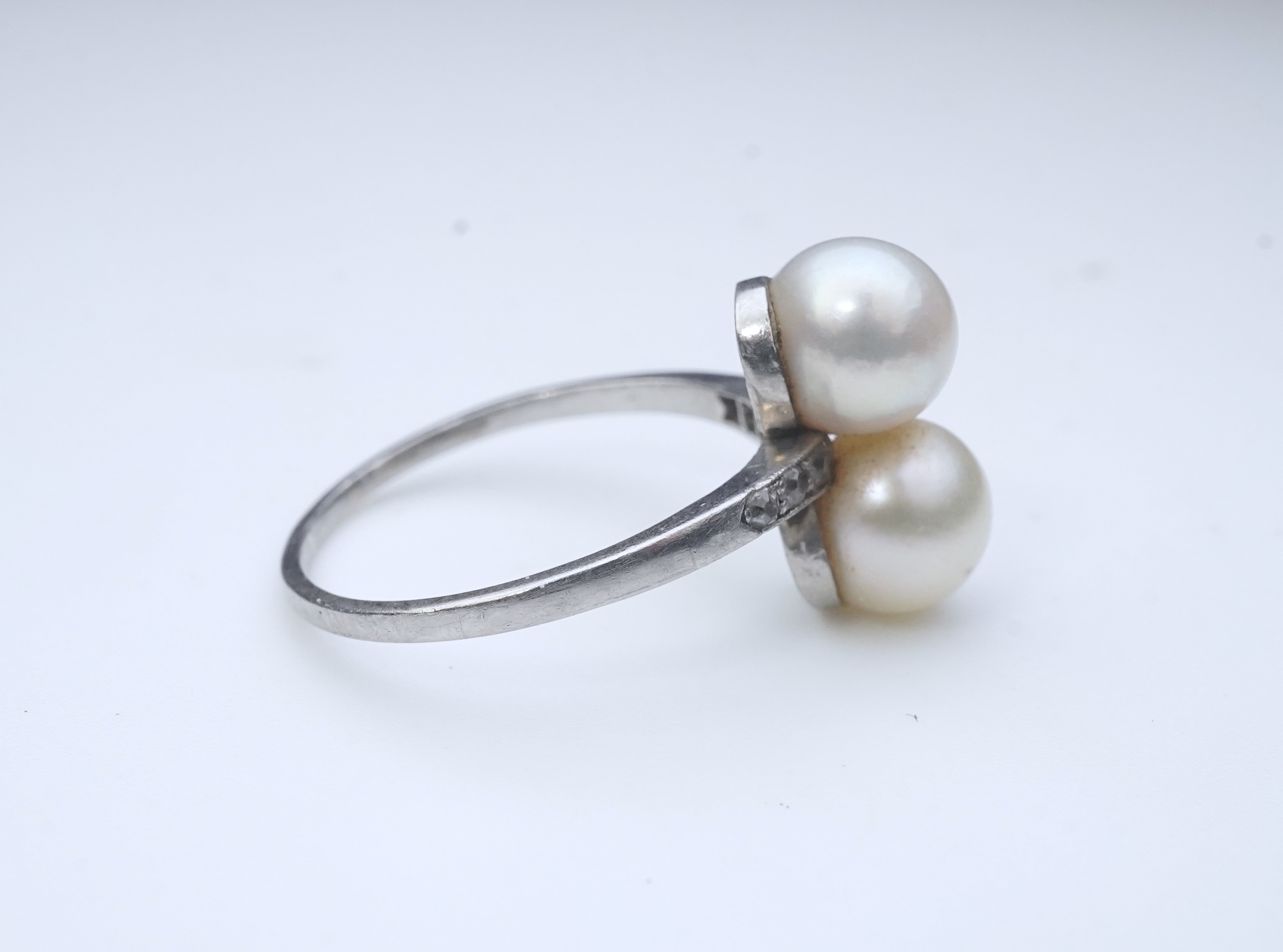 A pearl and diamond toi-et-moi ring, circa 1920